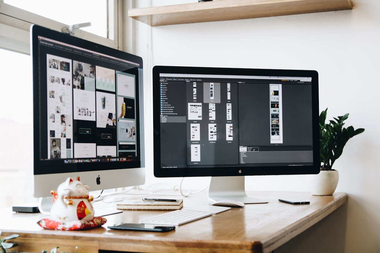 Crafting Captivating Headlines: Your awesome post title goes here Stylish office workspace featuring dual monitors, a keyboard, notebooks, and decorative plant.