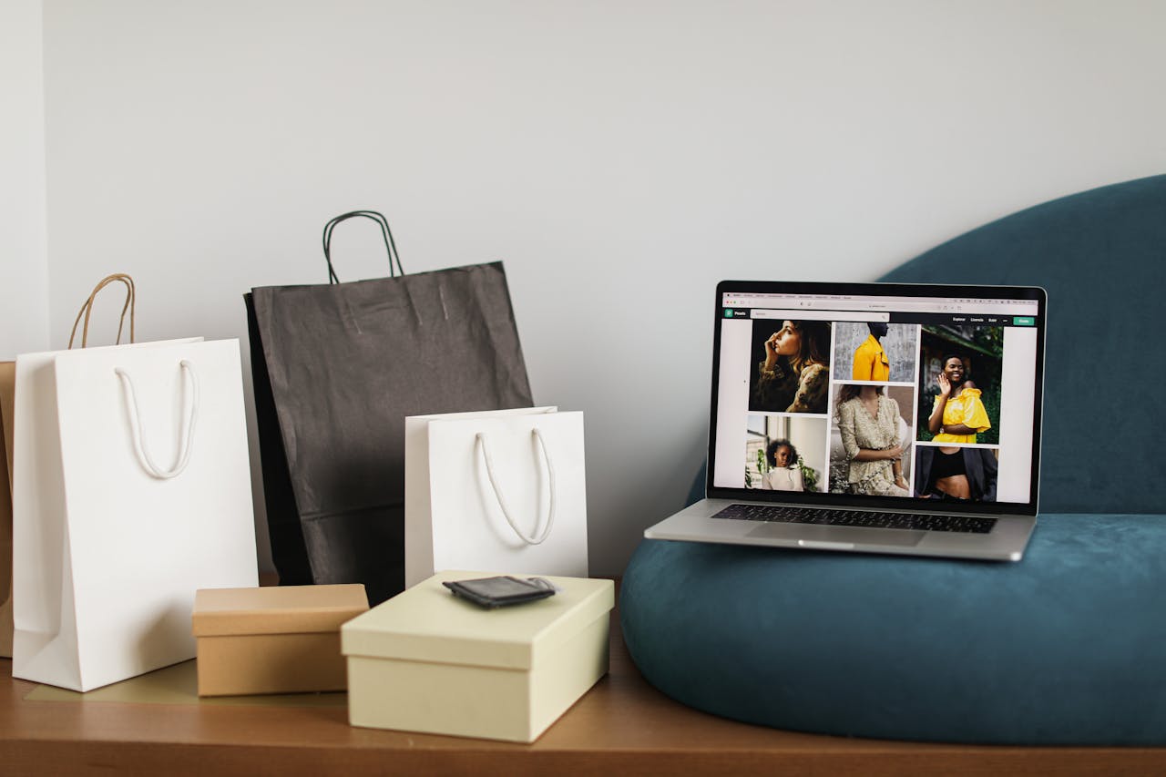 Services Laptop showcasing fashion e-commerce site alongside shopping bags, ideal for online shopping themes.